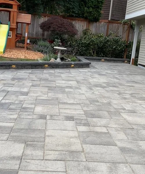 Installation of pavers. Retaining wall. Children's play area and installation of lights in Snohomish 